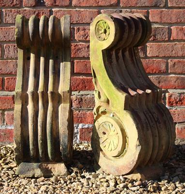 Lot 730 - A PAIR OF SCROLLING ARCHITECTURAL BRACKETS the fluted scrolls with rose head decoration to the sides