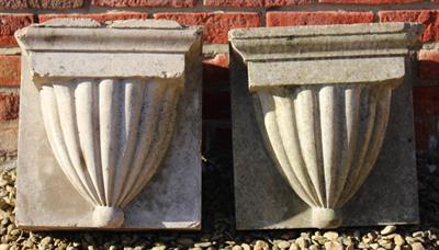 Lot 731 - A PAIR OF TERRACOTTA CORBELS with waisted fluted decoration 34cm wide x 34cm high