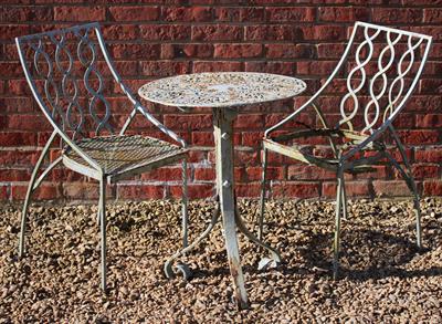 Lot 732 - A CAST AND WROUGHT IRON CIRCULAR GARDEN TABLE with pierced top and scrolling tripod base 58.5cm diam