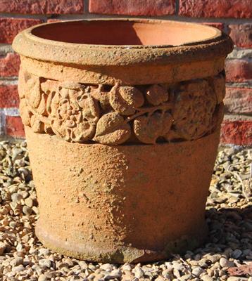 Lot 735 - AN EDWARDIAN TERRACOTTA CYLINDRICAL GARDEN PLANTER with a band of rose decoration