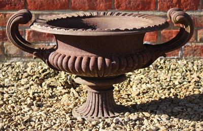 Lot 737 - AN OLD CAST IRON URN of shallow campana form with scrolling handles 51cm diameter x 41cm high