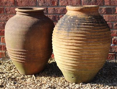 Lot 750 - A GREEK TERRACOTTA RIBBED OVOID PITHOI TYPE JAR or planter approximately 43cm diameter x 64cm high t