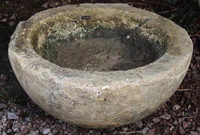 Lot 753 - AN OLD COTSWOLD STONE CIRCULAR SINK or bowl approximately 76cm diameter x 32cm high