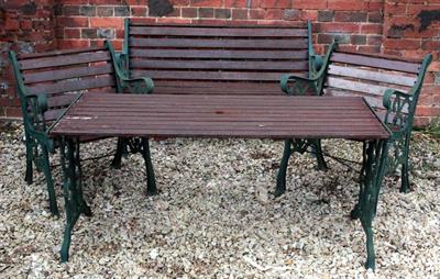 Lot 758 - A GREEN PAINTED GARDEN TABLE with scrolling cast iron ends and slatted top 140cm wide x 63.5cm high