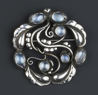 Lot 237 - Georg Jensen
'Moonlight' silver and moonstone brooch
with a bud and leaf scroll frame
numbered