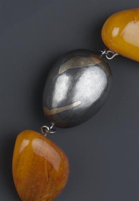 Lot 244 - Modernist School
Bi-metal necklace, probably continental
spaced with amber beads
stamped 'Silver 925