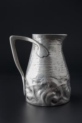 Lot 264 - Tudric
Pewter jug
decorated with fish amongst waves
stamped 'Tudric' and model number '0174'
17