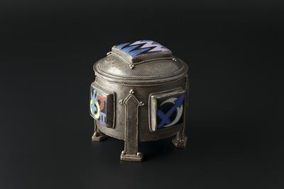 Lot 265 - Arts & Crafts
Continental silvered metal and enamel casket
with square enamel panels in black, blue