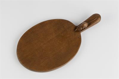 Lot 310 - Robert Thompson of Kilburn (British, 1876-1955)
Mouseman oak cheese board
carved mouse to the