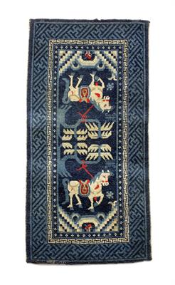 Lot 103 - A Chinese blue ground pony saddle rug