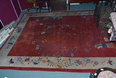 Lot 105 - A Chinese red ground carpet