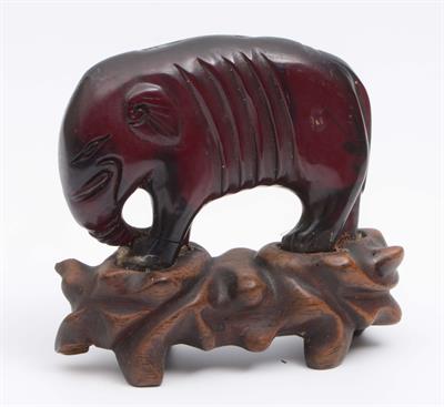 Lot 219 - A Chinese small carved amber elephant