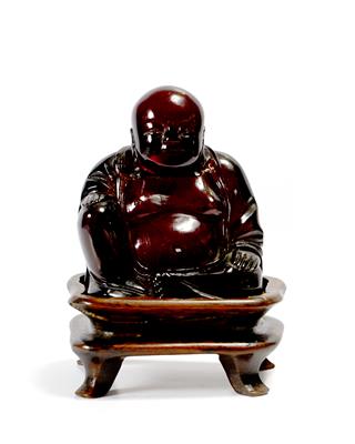 Lot 244 - A Chinese red amberoid figure