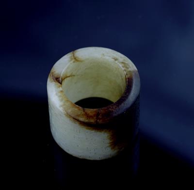 Lot 299 - A Chinese white and russet jade archer's ring