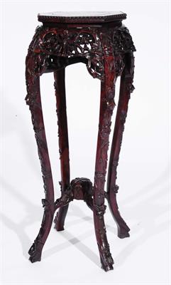 Lot 455 - A Chinese rosewood octagonal urn stand