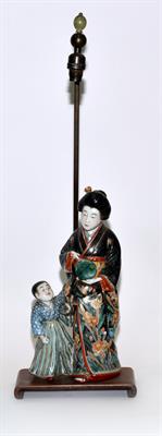 Lot 572 - A Japanese Imari porcelain figure group