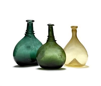 Lot 651 - Two Persian green glass saddle flasks