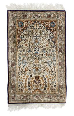 Lot 711 - A silk ivory ground Persian rug