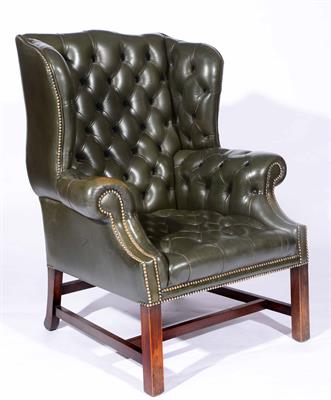 Lot 74 - A Georgian style green leather wingback armchair