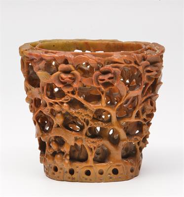 Lot 69 - A CHINESE CARVED SOAPSTONE BRUSH POT of open work form decorated with magnolia and fruit