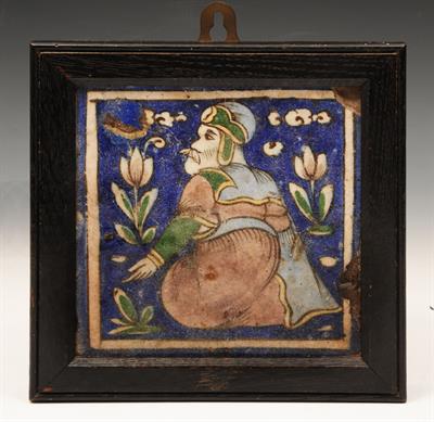 Lot 89 - A QAJAR TILE on cobalt blue ground decorated with a holy man