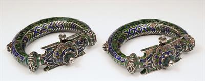 Lot 117 - A PAIR OF PERSIAN ENAMEL ANKLETS of stylised form with polychrome and relief decoration