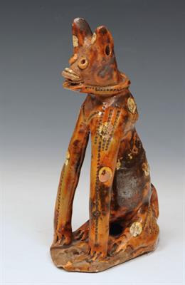 Lot 129 - A TURKISH CANAKKALE GLAZED POTTERY MODEL of a seated dog