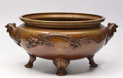 Lot 134 - A LARGE CHINESE BRONZE JARDINIERE with phoenix head handles and raised dragon designs on four