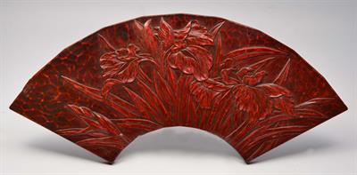 Lot 171 - A JAPANESE RED LACQUER PANEL in the form of a fan decorated with irises