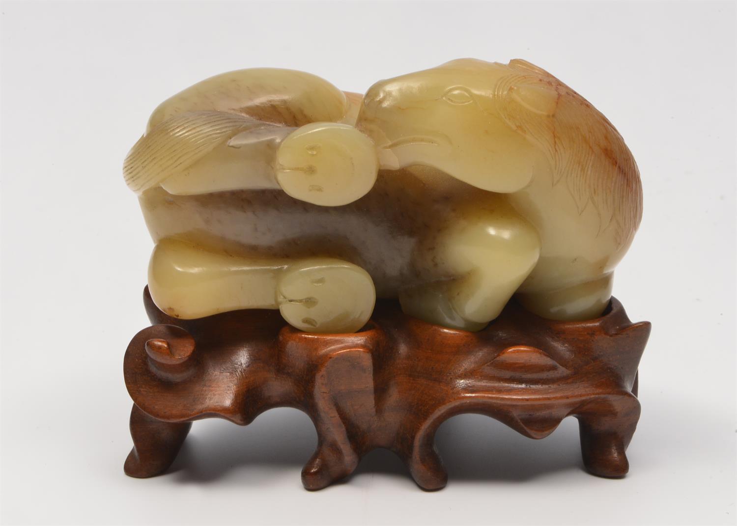 Lot 194 - A CHINESE JADE GREYISH GREEN AND BROWN STRIATED RECLINING HORSE