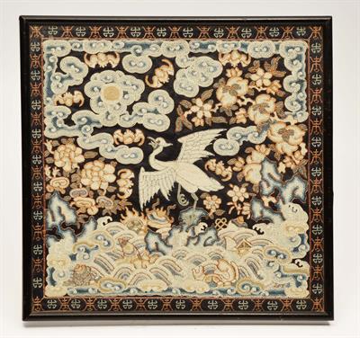 Lot 199 - A CHINESE EMBROIDERED RANK BADGE with central phoenix within a surround of stylised clouds and waves