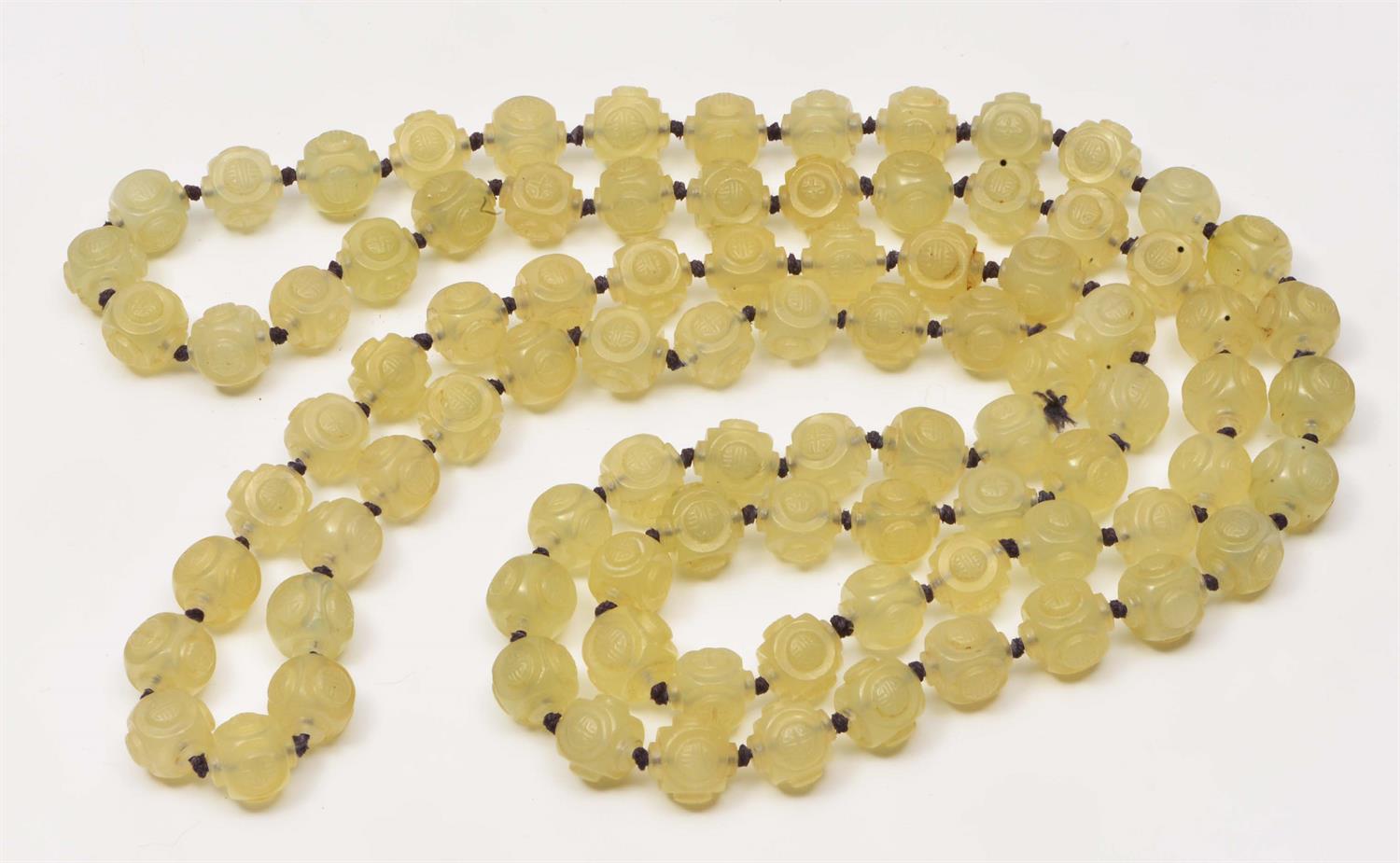 Lot 215 - A CHINESE PEKING GLASS LONG BEAD NECKLACE of pale green carved beads