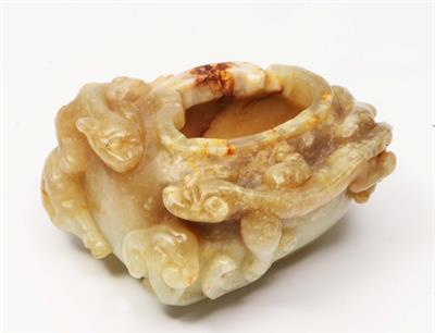 Lot 225 - A CHINESE WHITE AND GREY JADE BRUSH WASHER carved in relief with two chi-lin and ruyi fungus