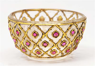 Lot 250 - A MUGHAL ROCK CRYSTAL SMALL BOWL having kundon work with rubies all over and a carved base