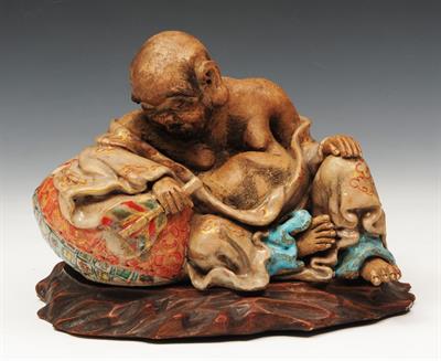 Lot 301 - A JAPANESE HIRADO MODEL of a seated Rakan resting on his sack