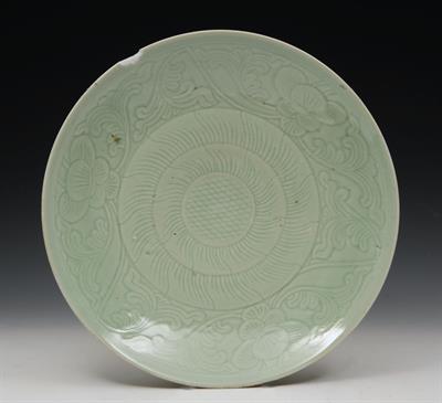 Lot 323 - A CHINESE LONGQUAN SHALLOW DISH with peony incised border and concentric circle designs