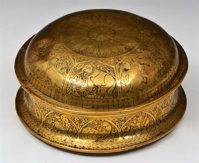 Lot 454 - AN INDIAN ENGRAVED BRASS PANDAN HOLDER of circular form with panels of elephants and other animals