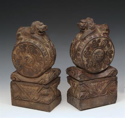 Lot 475 - A PAIR OF CHINESE BASALT MODELS of door guardians each  in the form of dog of fo resting on a drum