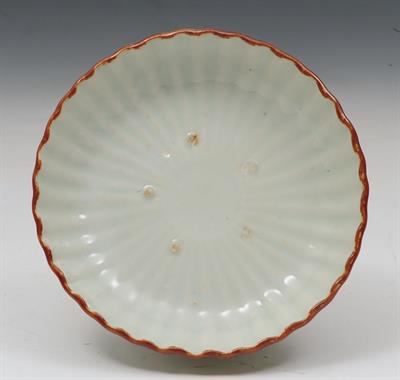 Lot 477 - A CHINESE CELADON GLAZE SMALL DISH with cafe-au-lait border of reeded form