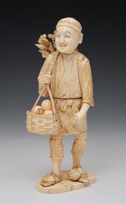 Lot 493 - A JAPANESE SECTIONAL OKIMONO of a standing farmer carrying a basket of fruit and a bundle of