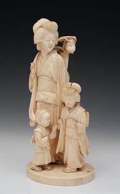 Lot 494 - A JAPANESE TOKYO SCHOOL IVORY OKIMONO of a standing figural group of mother carrying a symbolic