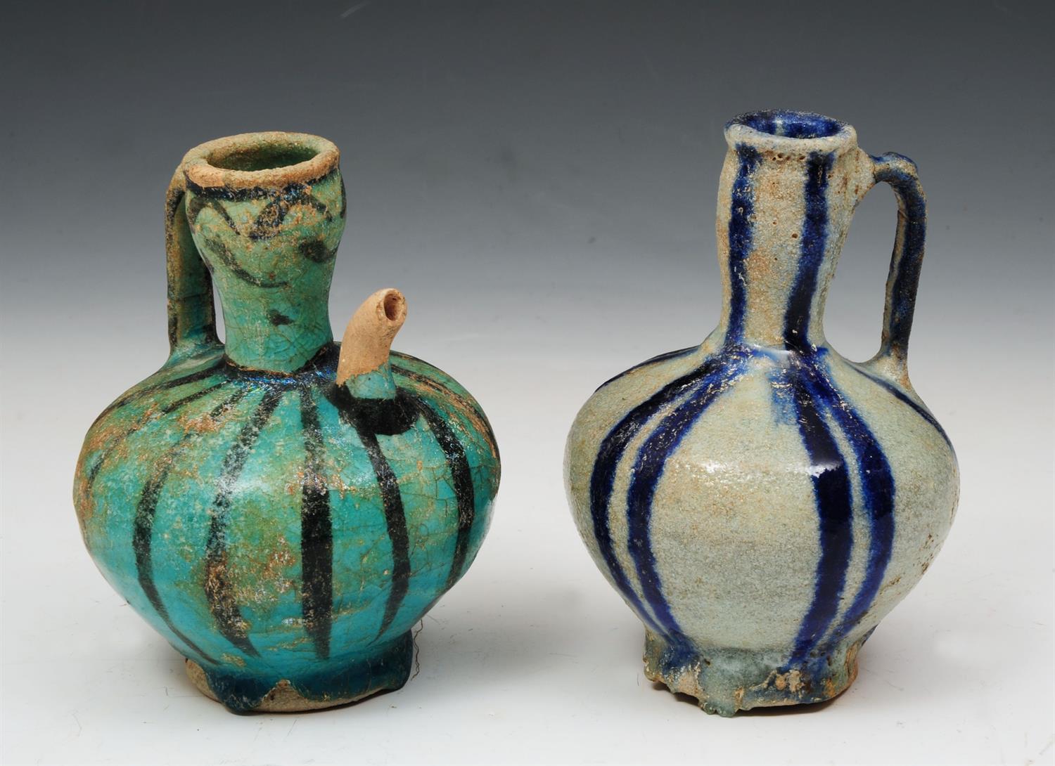 Lot 547 - TWO KASHAN POTTERY JUGS