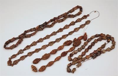 Lot 616 - THREE CARVED CORNELIAN NECKLACES and a Chinese carved nut necklace