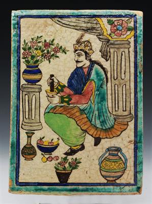 Lot 681 - A LARGE QAJAR POLYCHROME TILE with figure grinding spices within a turquoise border