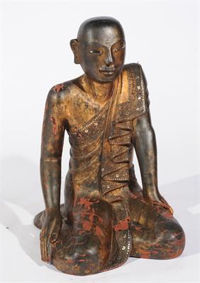 Lot 718 - A BURMESE LACQUER KNEELING BUDDHA with traces of gilding and inset silvered mounts