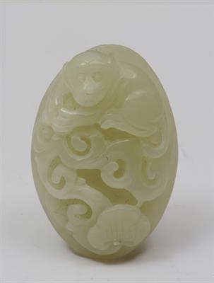 Lot 726 - A CHINESE JADE CARVED OVAL MOUNT in the form of a monkey and reyi