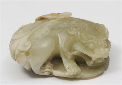 Lot 729 - A CHINESE CARVED JADE MODEL of a recumbent lion