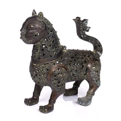 Lot 19 - AN EASTERN PATINATED BRONZE PIERCE DECORATED TEMPLE LION