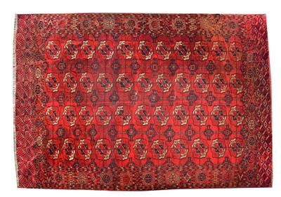 Lot 68 - AN ANTIQUE TURKOMAN RED GROUND MAIN CARPET decorated four rows of eleven guls within a wide border
