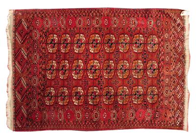 Lot 75 - A TURKOMAN DARK RED GROUND SMALL RUG decorated with three rows of eight guls within a multiple